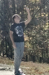 Photo of Steven trying to get cell service